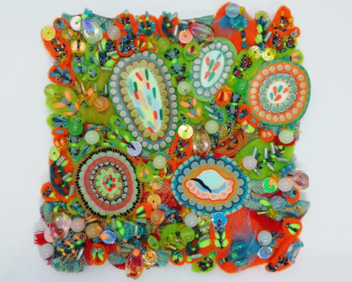 This mini textile artwork is inspired by the vibrant colours of Florida and is full of bright orange and green stitched pieces of felt which surrounds 5 painted concentric circles with quirky abstract centres. It's a very textured picture with lots of beads stitched into the fabrics throughout.