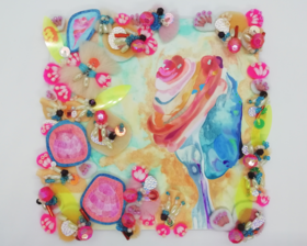 An abstract conch shell is painted in Gouache, ink and pencil onto the centre-right side of a 5 inch square wooden panel in pink, red and blue colours with a hint of purple. The background is a delicate painting of the sand with puddles of clear aquamarine water. Small handstitched pieces of abstract shaped fabrics and beads travel around on all side on the top of the art. 3 shells are drawn on paper and are on the left. There are chunky pink beads and lots of cream seed beads stitched into the fabrics.